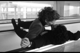 Sally Potter and Pablo Veron kiss on an airport travelator in The Tango Lesson